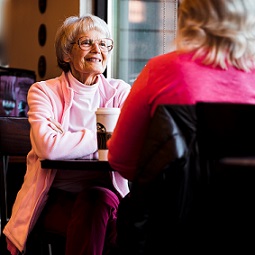 older mom and daughter in coffee shop