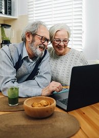older white couple with computer